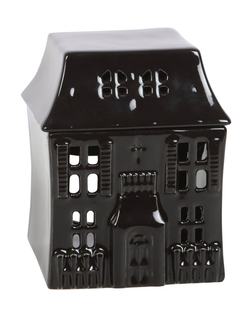The full view of the haunted house oil burner with gothic detailing, tiny window cutouts, and a pointed roof, against a neutral background.