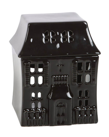 The full view of the haunted house oil burner with gothic detailing, tiny window cutouts, and a pointed roof, against a neutral background.