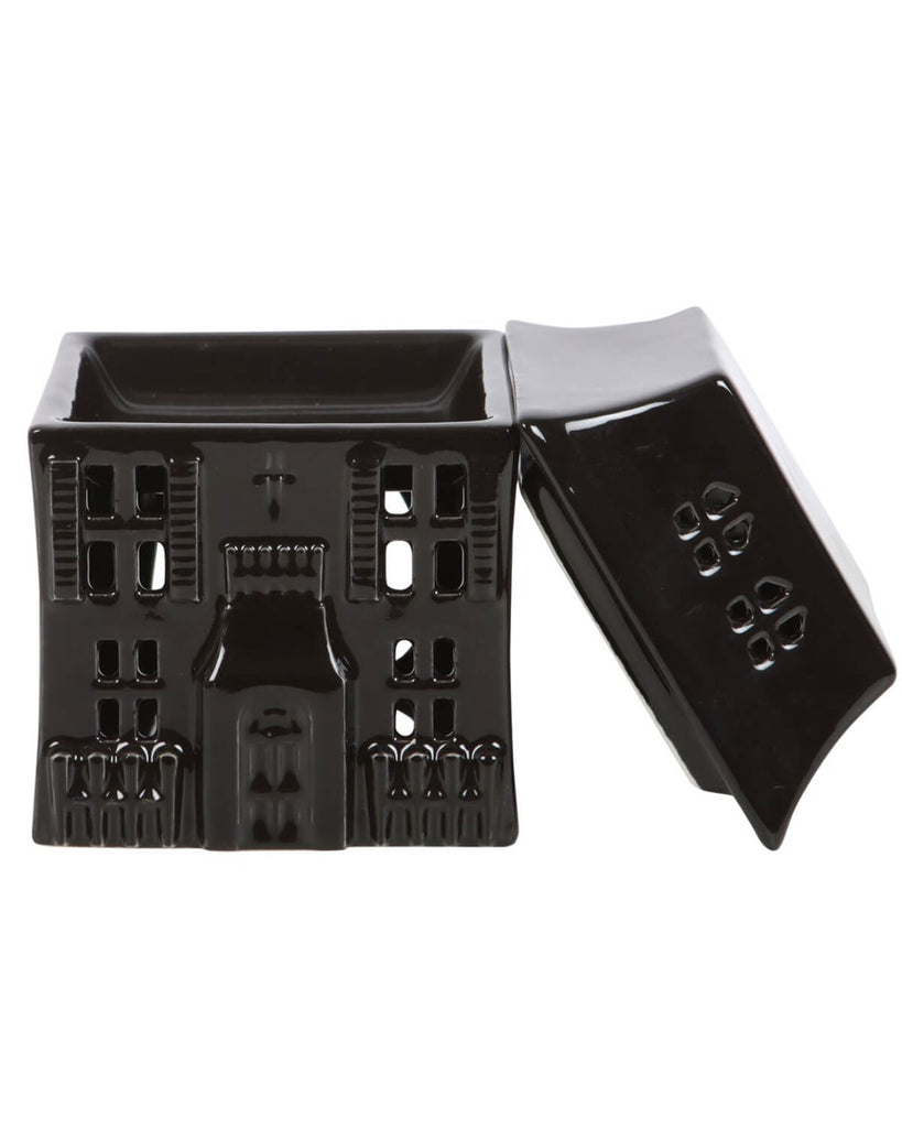 The haunted house oil burner with its removable roof lifted off, revealing the bowl for wax melts or oil.