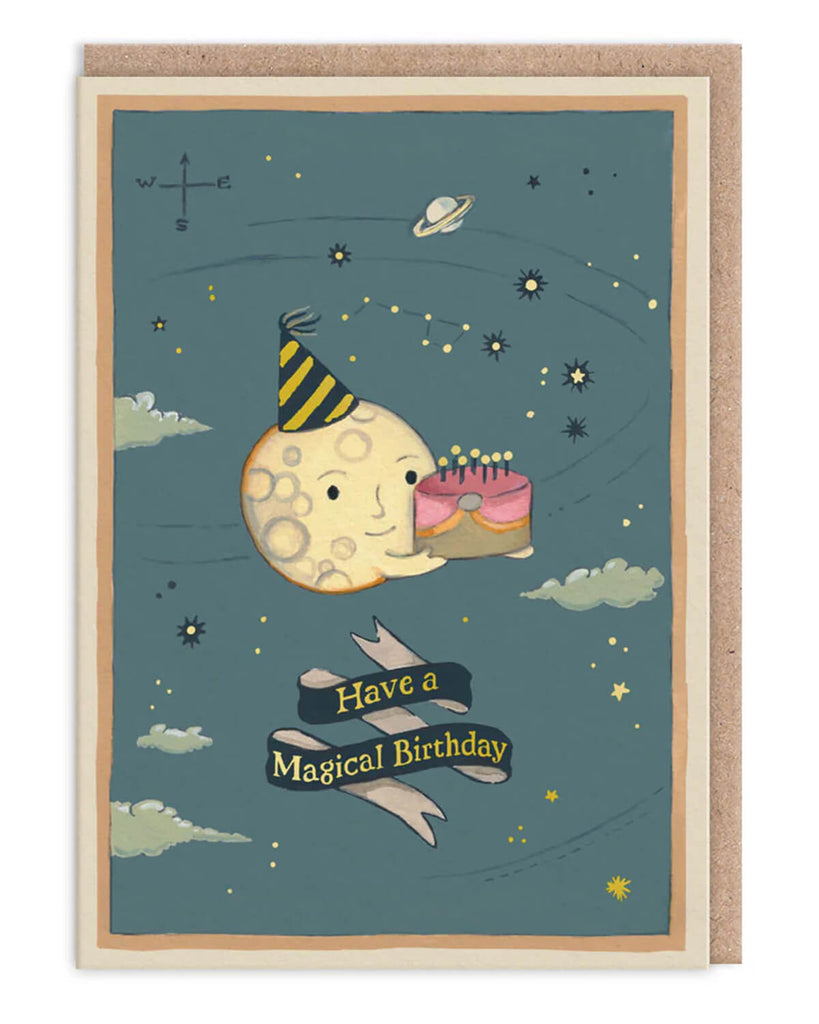 Whimsical Moon Cake Birthday Card from Rebel Romance featuring a cheerful cartoon moon wearing a party hat and holding a pink birthday cake with candles. Surrounded by stars, constellations, and planets in a magical night sky, with the words "Have a Magical Birthday" on a ribbon banner. Perfect for celestial lovers and alternative gift-givers, ideal for millennials who adore quirky and cosmic-themed stationery.