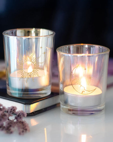 The sun and moon candle holders lit with tealights inside, casting a warm, magical glow.