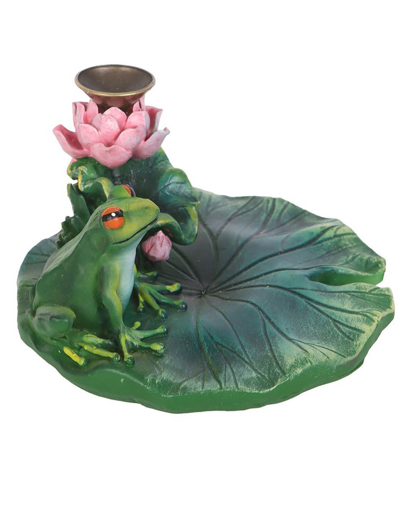 A close-up of the resin lily pad backflow incense burner with a green frog and pink lotus flower on a textured lily pad base.