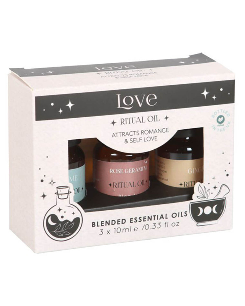 Front-facing boxed set with cut-out windows showing the three essential oil bottles against the Herbal Magick-themed packaging.