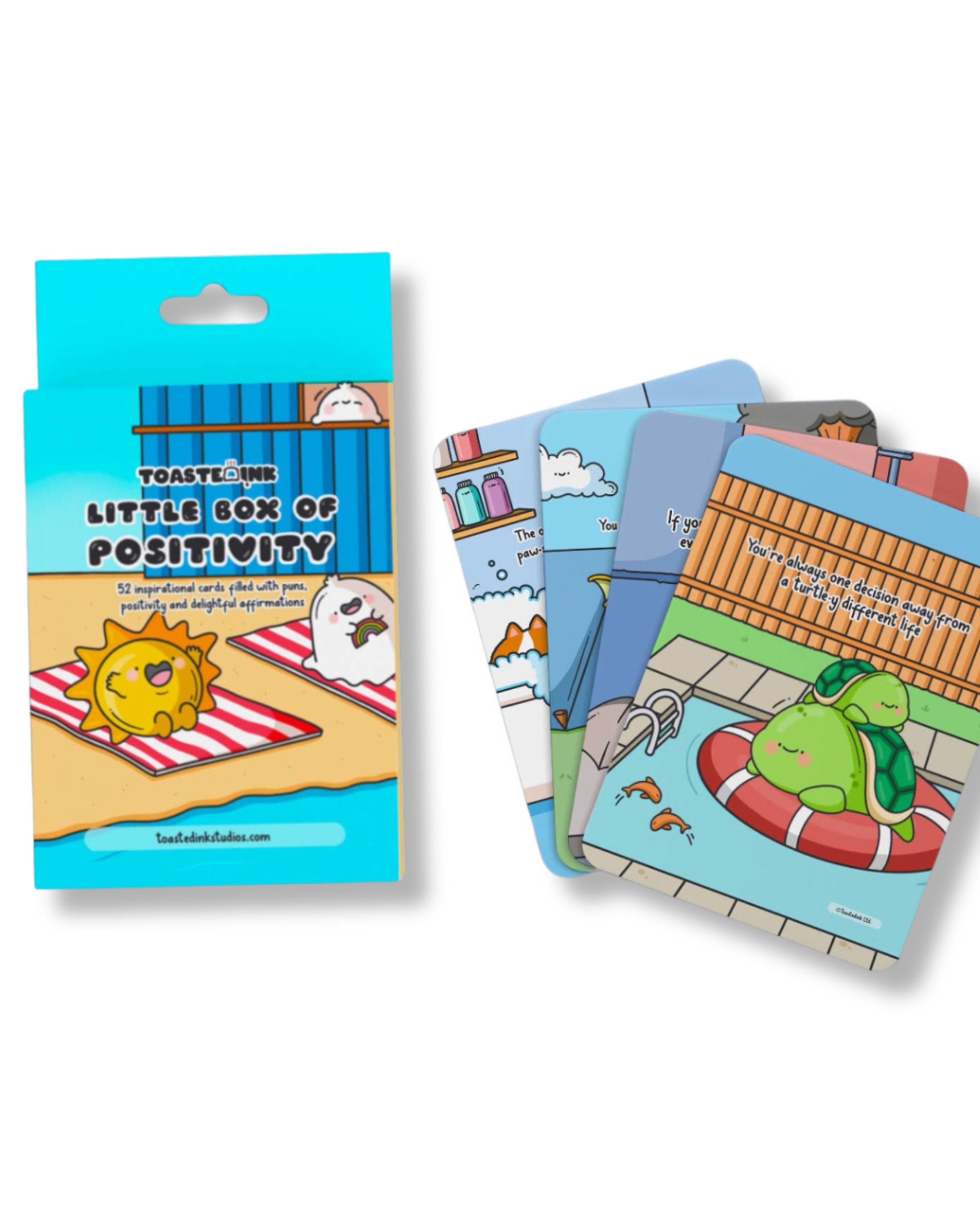A blue box titled “Little Box of Positivity” surrounded by several colourful Toastedink affirmation cards with punny, illustrated designs.