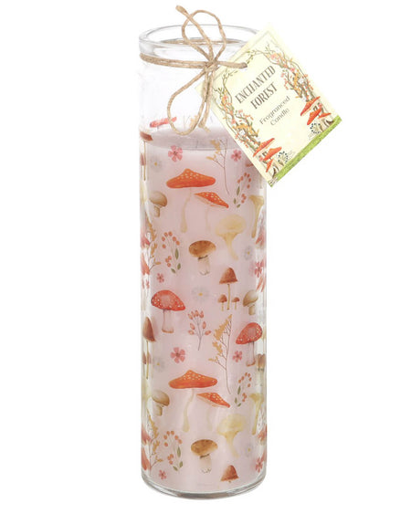 Close-up of the mushroom-print tube candle with an earthy design of toadstools, flowers, and leaves, tied with rustic twine and a gift tag against a white background.