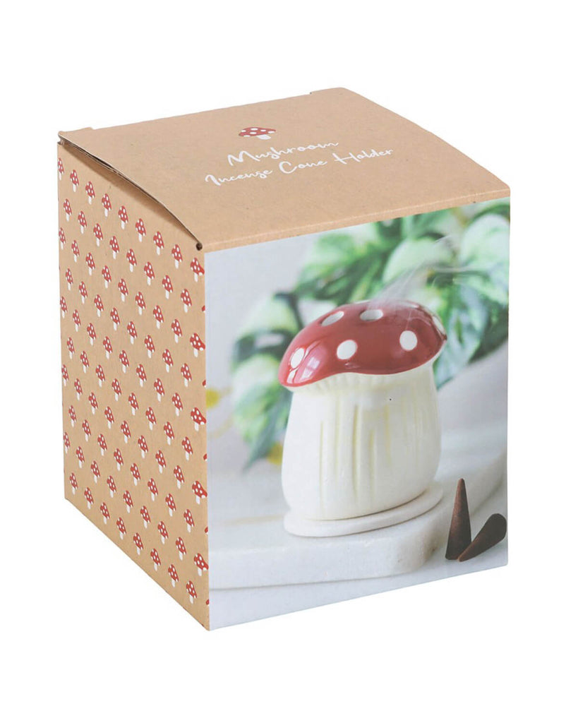Top-down view of the mushroom incense cone holder, highlighting its glossy red cap with white spots and a small hole for the incense cone.