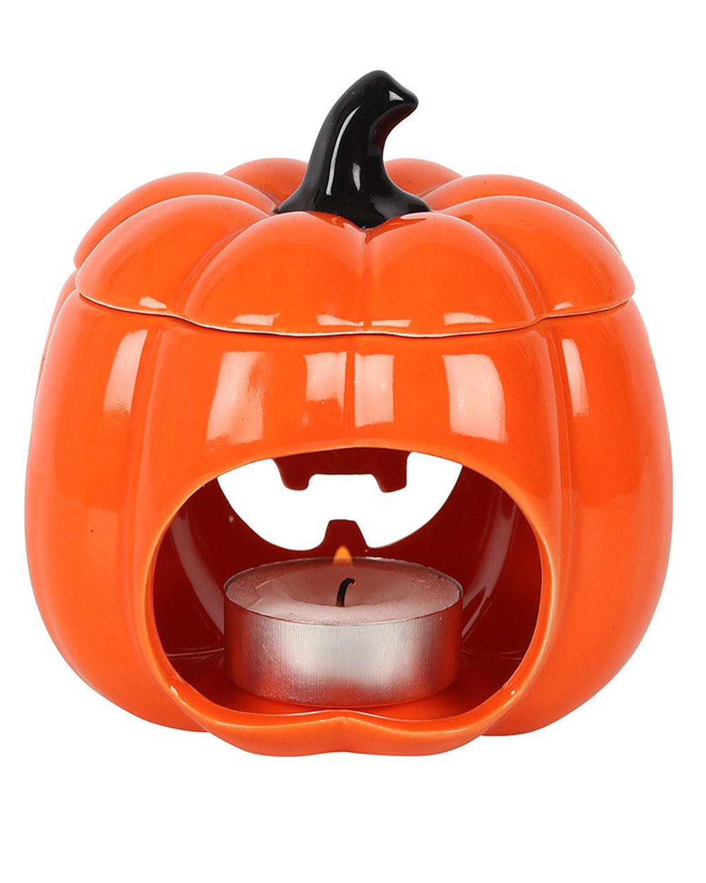 Front-facing view of the oil burner with a lit tealight, showing the open mouth and carved eyes of the Jack-O’-Lantern.