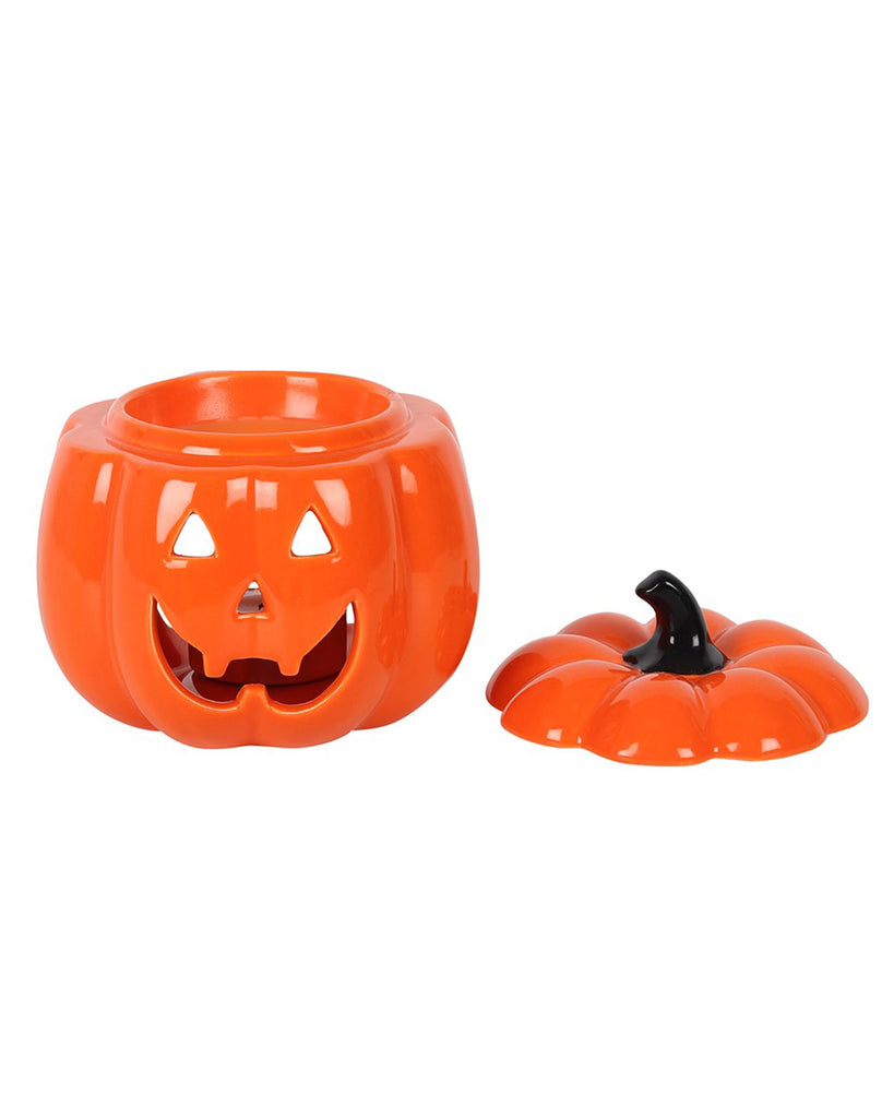 Oil burner with the lid removed, revealing the hollow interior and large opening for a tealight, with carved face details.