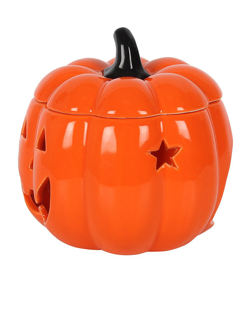 Side view of the Jack-O’-Lantern ceramic oil burner with a glossy orange finish, star-shaped cutouts, and a black pumpkin stem.