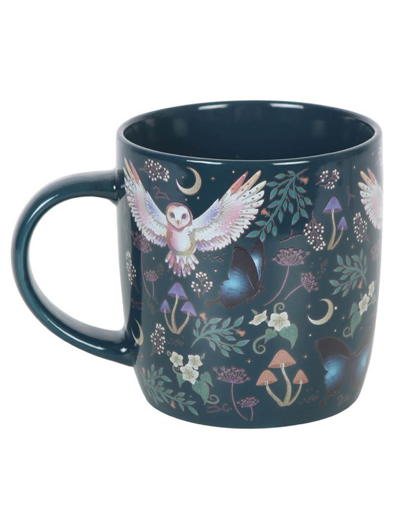 A side profile of the mug with the same intricate night-themed print, highlighting the curved handle and smooth ceramic surface.