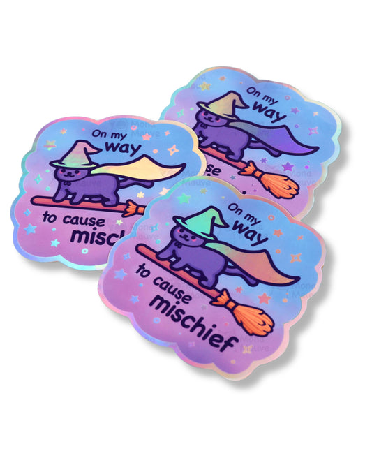 Three colorful stickers with a cat in a witch hat and cape, labeled 'On my way to cause mischief', on a white background.