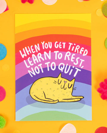A bright A6 postcard featuring a sleeping yellow cartoon cat under the phrase “When You Get Tired Learn to Rest, Not to Quit” on a rainbow background. Designed by Katie Abey, this calming and motivational postcard is perfect for millennials into alternative stationery, mental health positivity, and colourful self-care reminders.