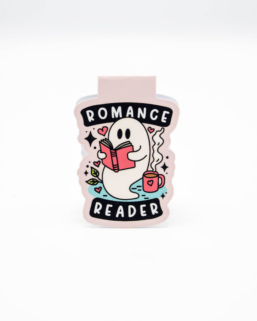 Cute magnetic bookmark from Rebel Romance featuring a cartoon ghost reading a red book with a pink mug nearby and hearts floating around. The text reads “Romance Reader” in bold lettering on a soft pastel background. Perfect for book lovers, ghost fans, and cosy readers with a spooky-sweet side. A fun and functional gift for millennials who adore quirky stationery and romantic reads.
