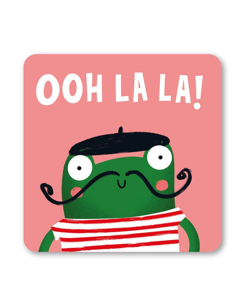 A square French Frog Coaster by Lucy Maggie Designs, featuring a cute green frog with wide eyes, a twirly black moustache, red cheeks, a red-and-white striped top, and a black beret. The phrase “Ooh La La!” is written in white, bold, uppercase letters against a soft pink background.
