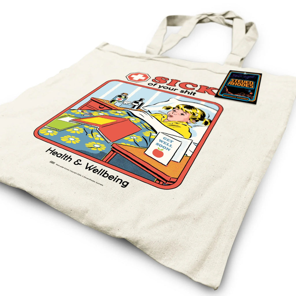 A natural cotton tote bag featuring Steven Rhodes’ retro-style artwork. The design shows a child in bed with a “Get Well Soon” card and the bold text “Sick of Your Shit” above, with “Health & Wellbeing” written below. The bag is eco-friendly and officially licensed merchandise.