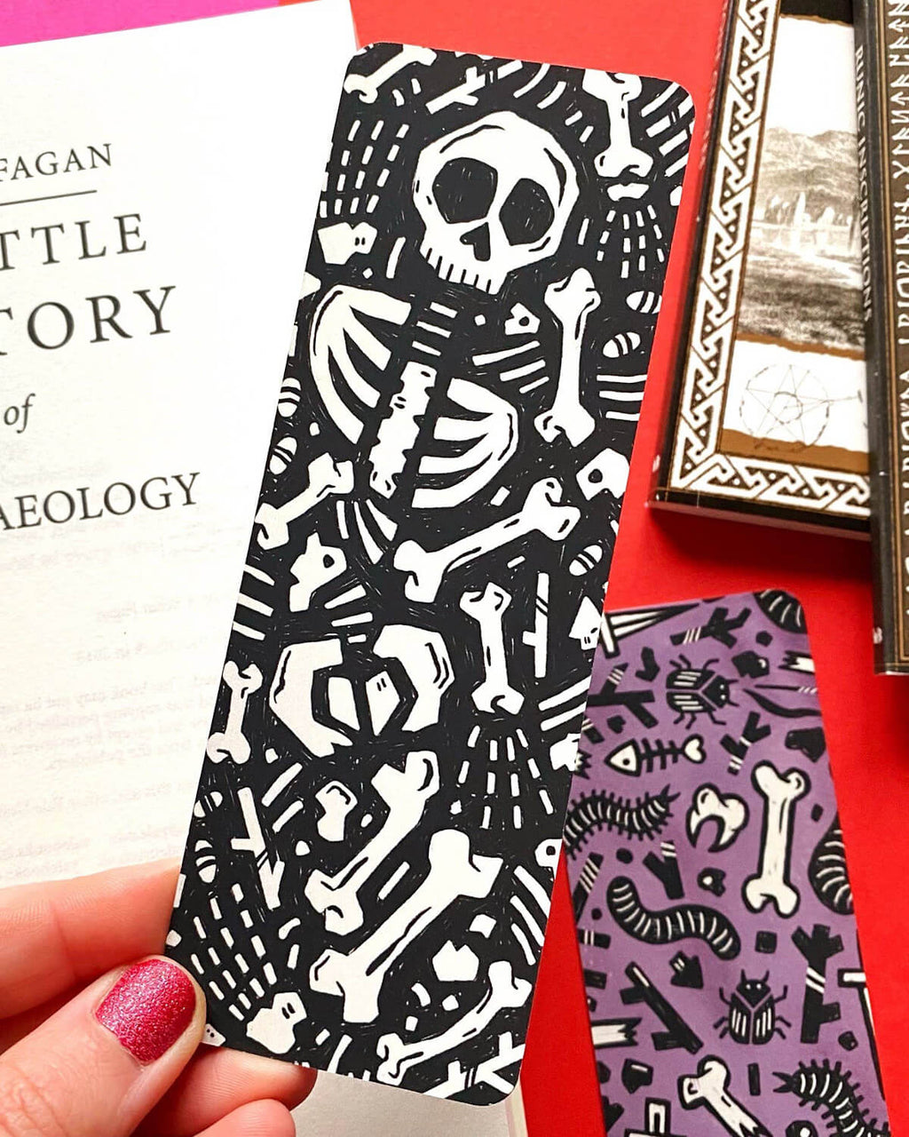 Discover the Skeleton Archaeology Bookmark – featuring double-sided skeleton and dig designs with a luxurious velvet matte coating. Perfect for history buffs and book lovers, this 14.8 x 5.2 cm bookmark is professionally printed in the UK!