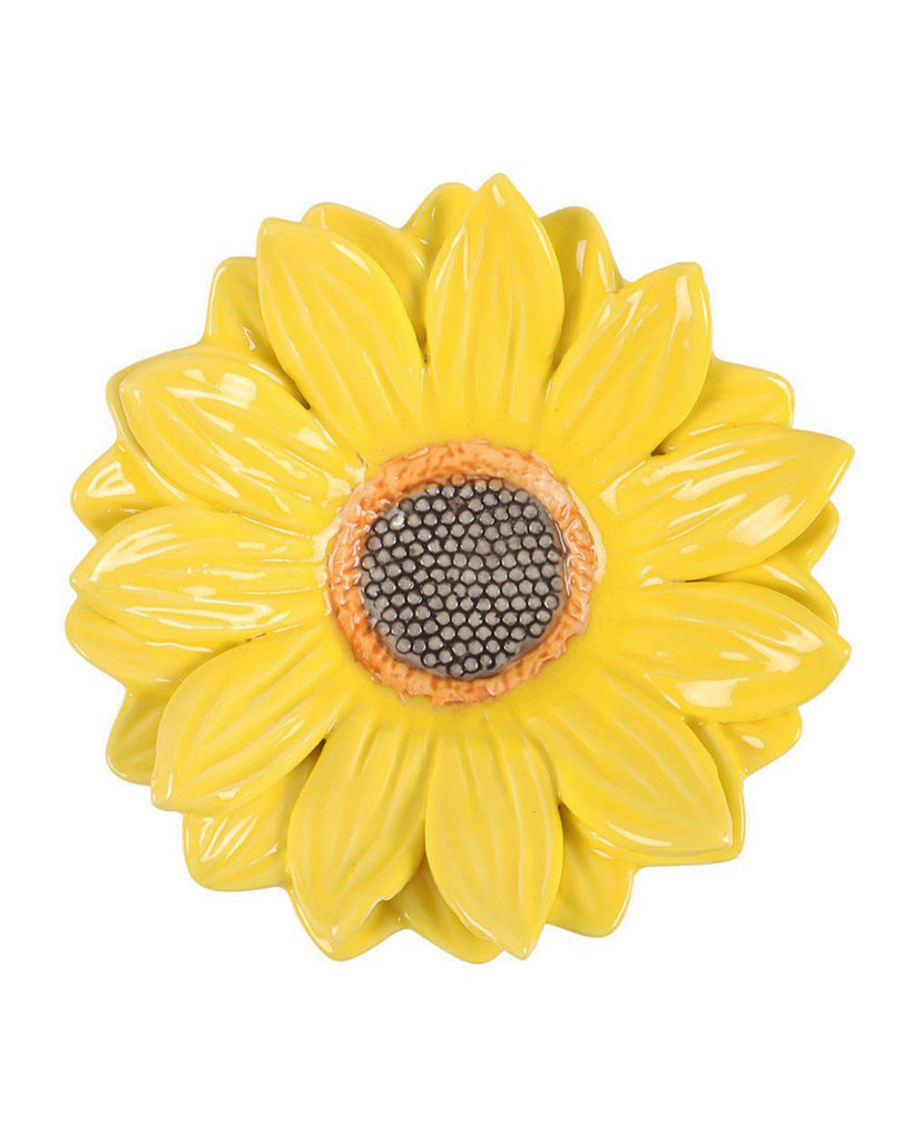 Close-up view of the sunflower-shaped ceramic trinket dish with bright yellow petals and a textured seed centre.