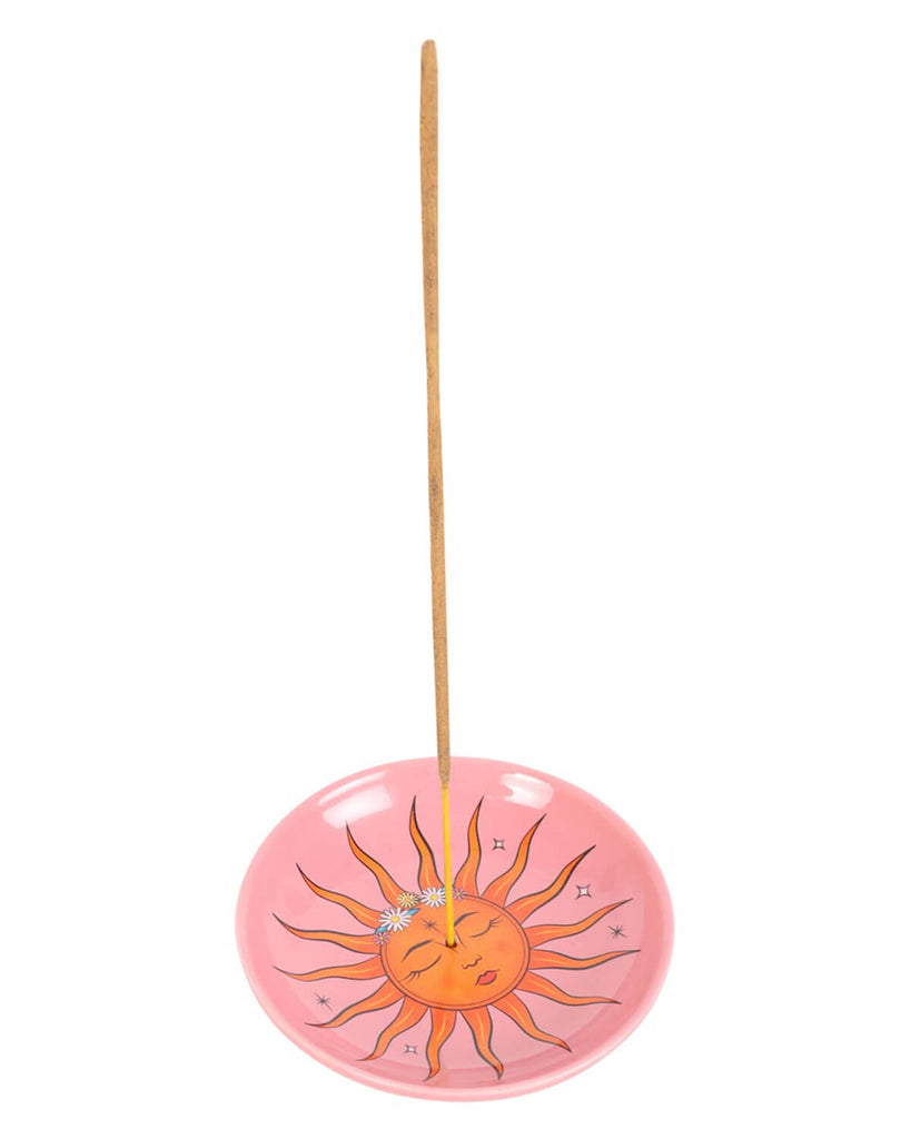 Close-up of the vibrant sun design, surrounded by rays and stars, with a central incense hole.