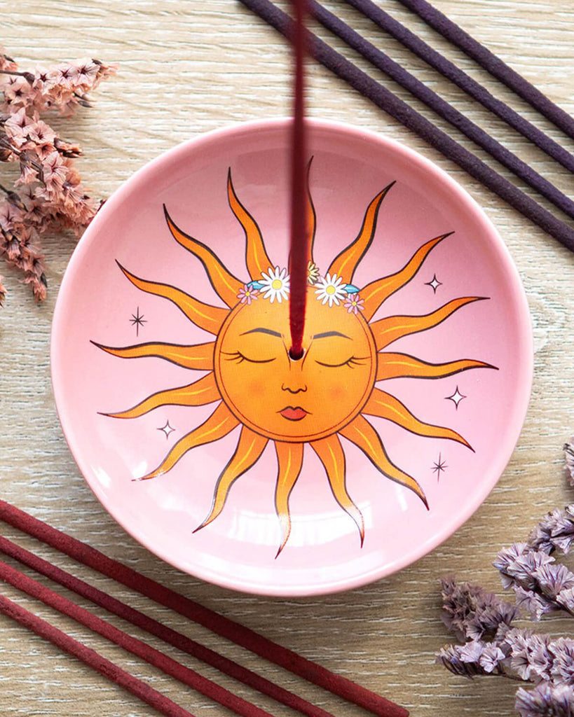 Incense holder styled with an incense stick, adding a mystical vibe to a vanity setup.