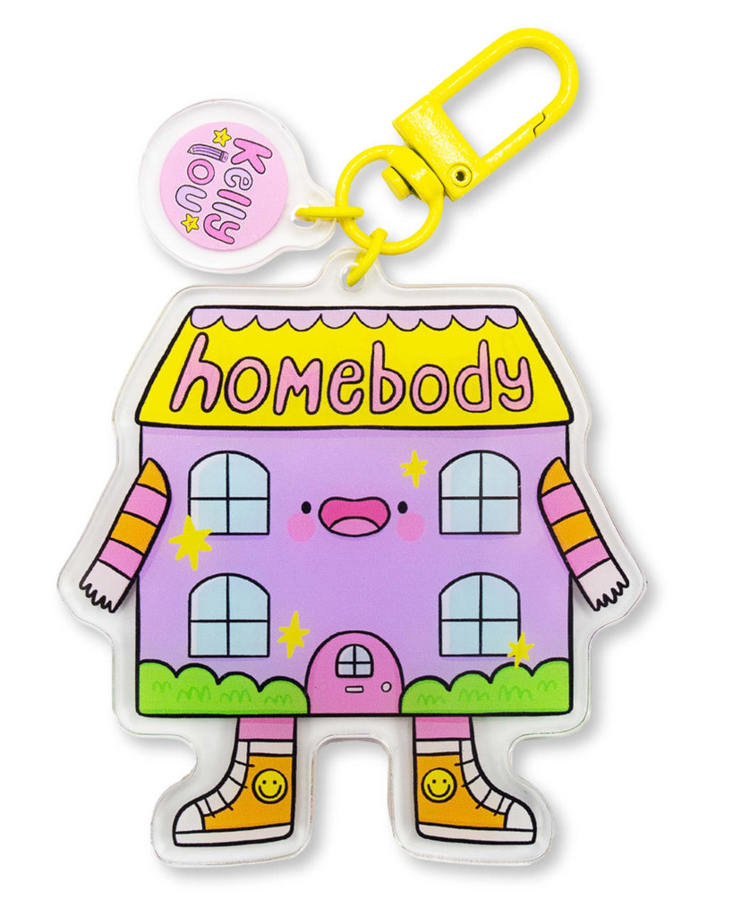 Cute lilac acrylic keyring by Kelly Lou featuring a smiling cartoon house with stripy arms and yellow shoes reading Homebody on the roof with a bright yellow clasp made from recycled acrylic and double-sided design perfect for keys or bags