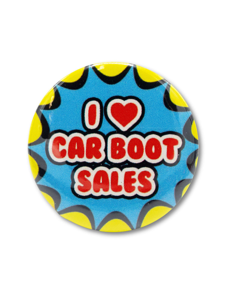 Blue button badge that reads 'I ❤️ Car Boot Sales' in red bubble text on a blue and yellow burst star background. A retro nostalgic style design from Bite Your Granny.