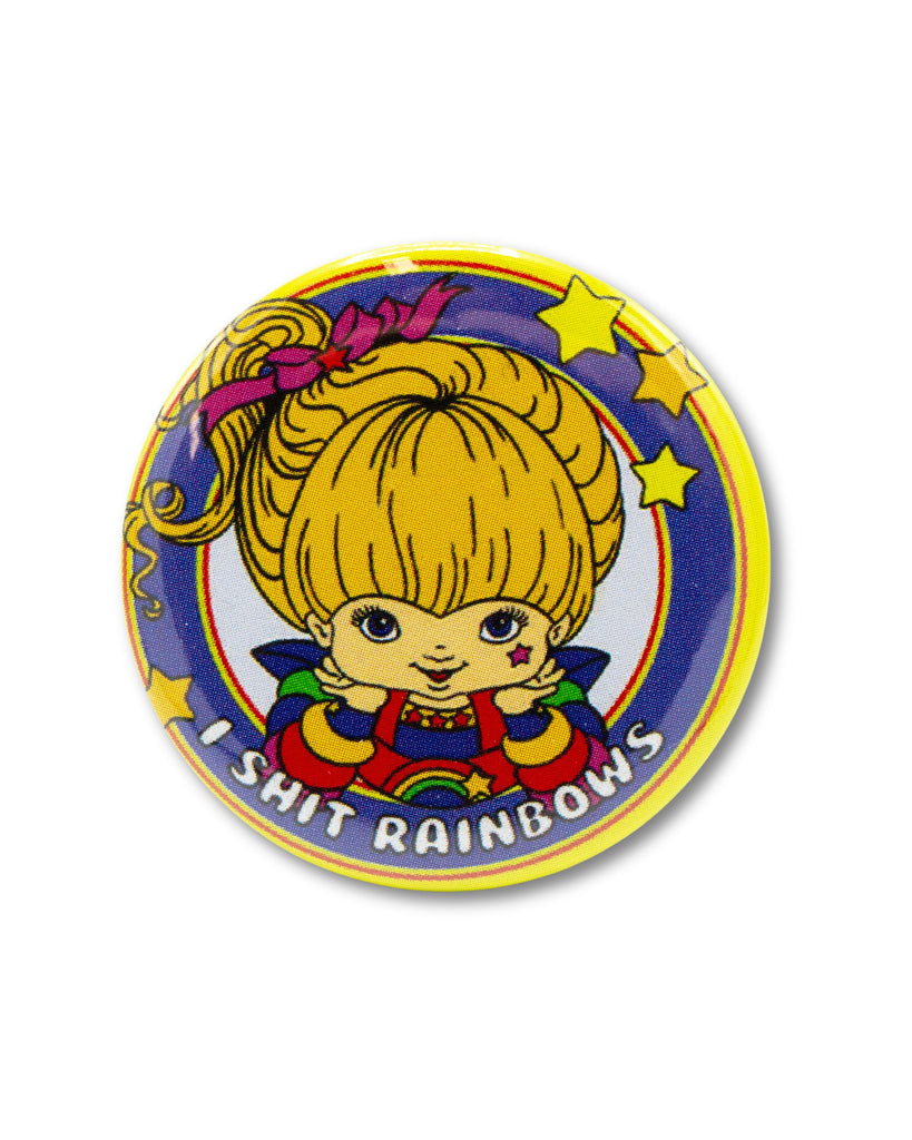 Blue and yellow button badge with a rainbow brite cartoon character and text that reads 'I Shit Rainbows' . A retro 80s cartoon design from Bite Your Granny.