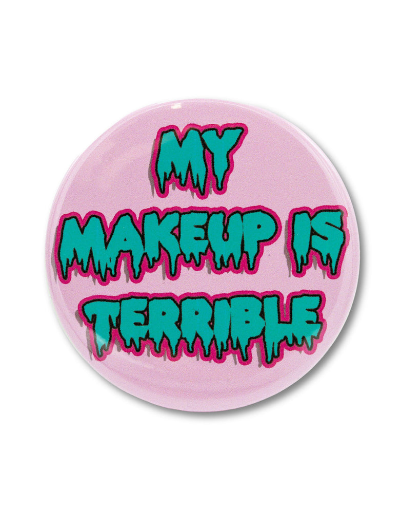 Pink pocket mirror with blue halloween spooky bubble writing that reads 'My Makeup is Terrible'. A drag queen drag race quote design from Bite Your Granny.