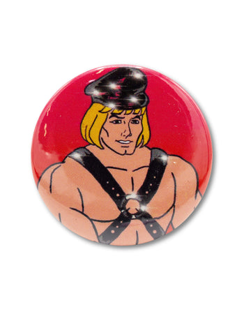 Red button badge with a cartoon character, he man, wearing a fetish outfit with sparkles. An 80s retro design from Bite Your Granny.