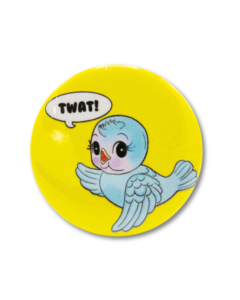 Round yellow button badge with a cartoon kitsch blue bird and speech bubble saying 'TWAT!' . A retro inspired design from Bite Your Granny.