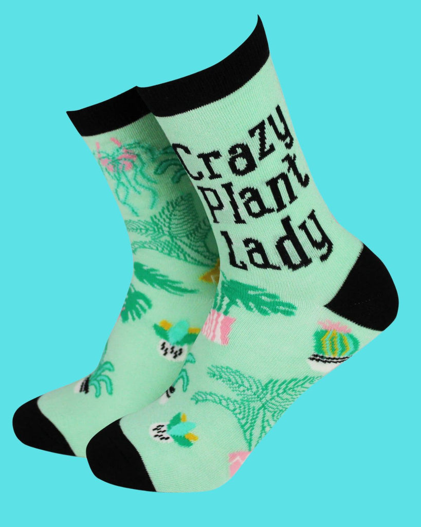 Eco-friendly Smiling Faces mint-green socks with fun plant patterns and the slogan 'Crazy Plant Lady'. Made from soft bamboo fabric with black accents, the perfect gift for gardeners, from Rebel Romance.