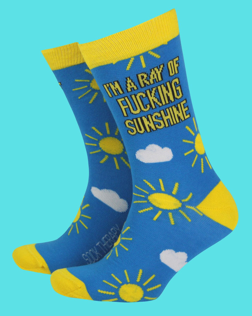 Pair of blue and yellow Rebel Romance bamboo socks with sun and cloud illustrations and the bold slogan “I’m a ray of fucking sunshine” in black and yellow text. Fun, eco-friendly socks in UK size 8–11 for those with a cheeky sense of humour. Designed by a UK small business celebrating alternative style, comfort, and expressive fashion.