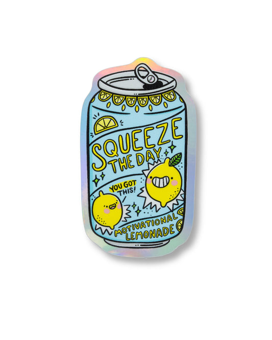Holographic vinyl sticker shaped like a fizzy drink can, designed by Kellylou and sold by Rebel Romance. The can reads “Squeeze the Day” with two happy lemon characters and the phrase “Motivational Lemonade” in bold text. One lemon shouts “You got this!” The background is iridescent with pastel rainbow tones. A quirky, positive sticker perfect for laptops, water bottles or notebooks.