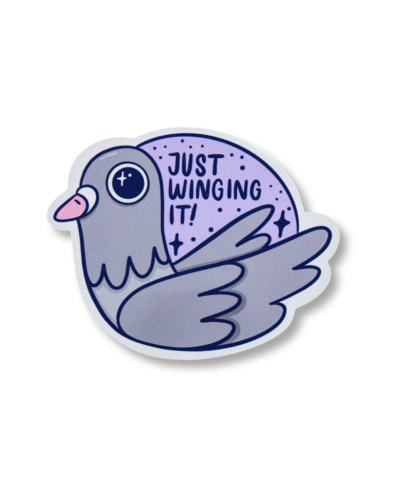 Glossy vinyl sticker featuring a cute grey pigeon with a pink beak and sparkly eyes, perched in front of a purple circle with stars and the words “Just Winging It!” in bold lettering. Designed by Kellylou for Rebel Romance, a UK brand celebrating quirky, alternative style and millennial vibes. Perfect for journalling, scrapbooking, or decorating your laptop or notebook.