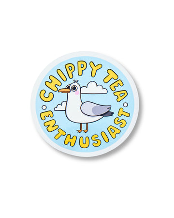 Circular glossy sticker from Rebel Romance featuring a cartoon seagull with the words “Chippy Tea Enthusiast” in bold yellow text. Set against a blue sky with white clouds, this illustrated design by Kellylou celebrates your love for the great British chippy tea. Fun and quirky gift for takeaway fans and seagull lovers.
