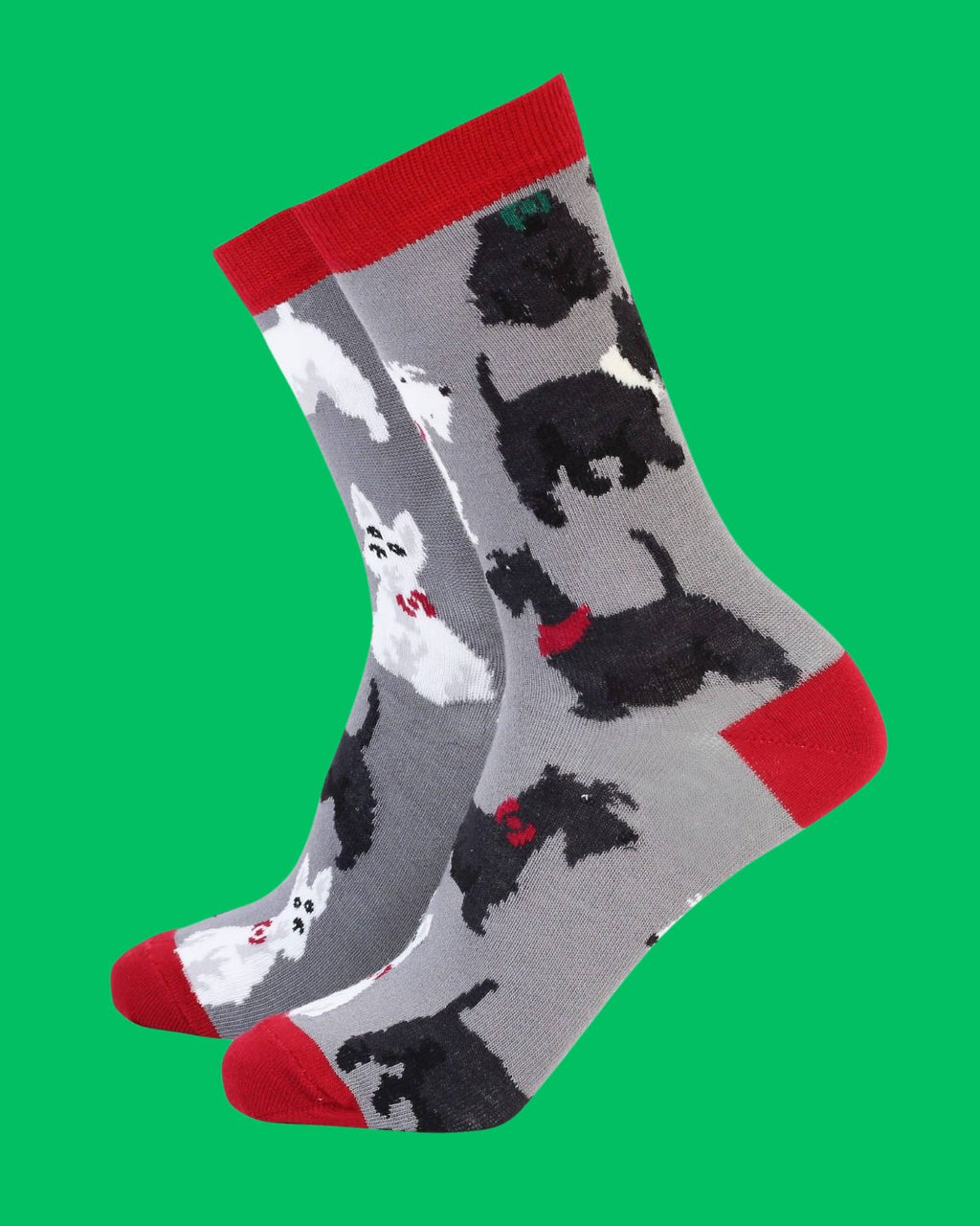 Grey novelty bamboo socks with red accents and repeated black and white Scottie dog pattern, shown on green background.