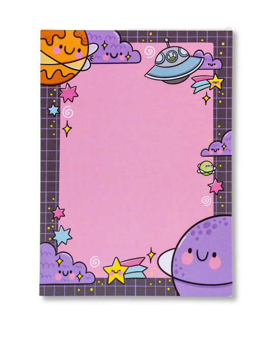 A cute A6 notepad from Rebel Romance featuring a pastel space theme illustrated by Kellylou. The pink background is framed by kawaii-style smiling planets, stars, clouds, and a flying saucer with a tiny alien. Grid-style borders and colourful characters give it a fun retro vibe. A perfect gift for space lovers and stationery fans.