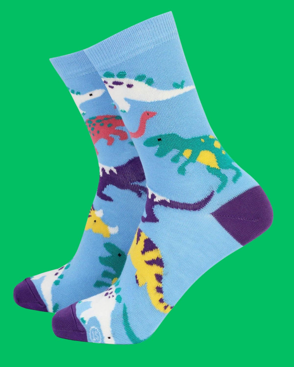 miling Faces eco bamboo socks with multicoloured dinosaurs on a sky blue background and bold purple accents. Sustainable and playful socks available at Rebel Romance.
