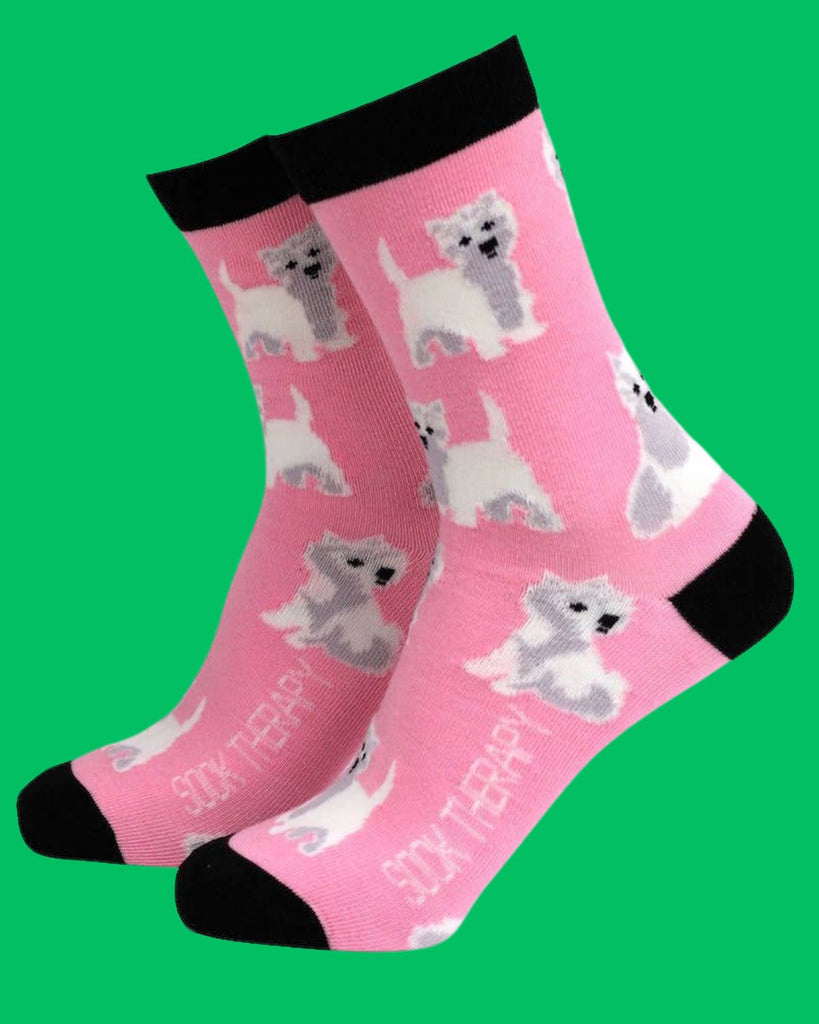 Smiling Faces bamboo socks featuring cute West Highland White Terriers on a bright pink background with black trim. Eco-friendly novelty socks available at Rebel Romance.

