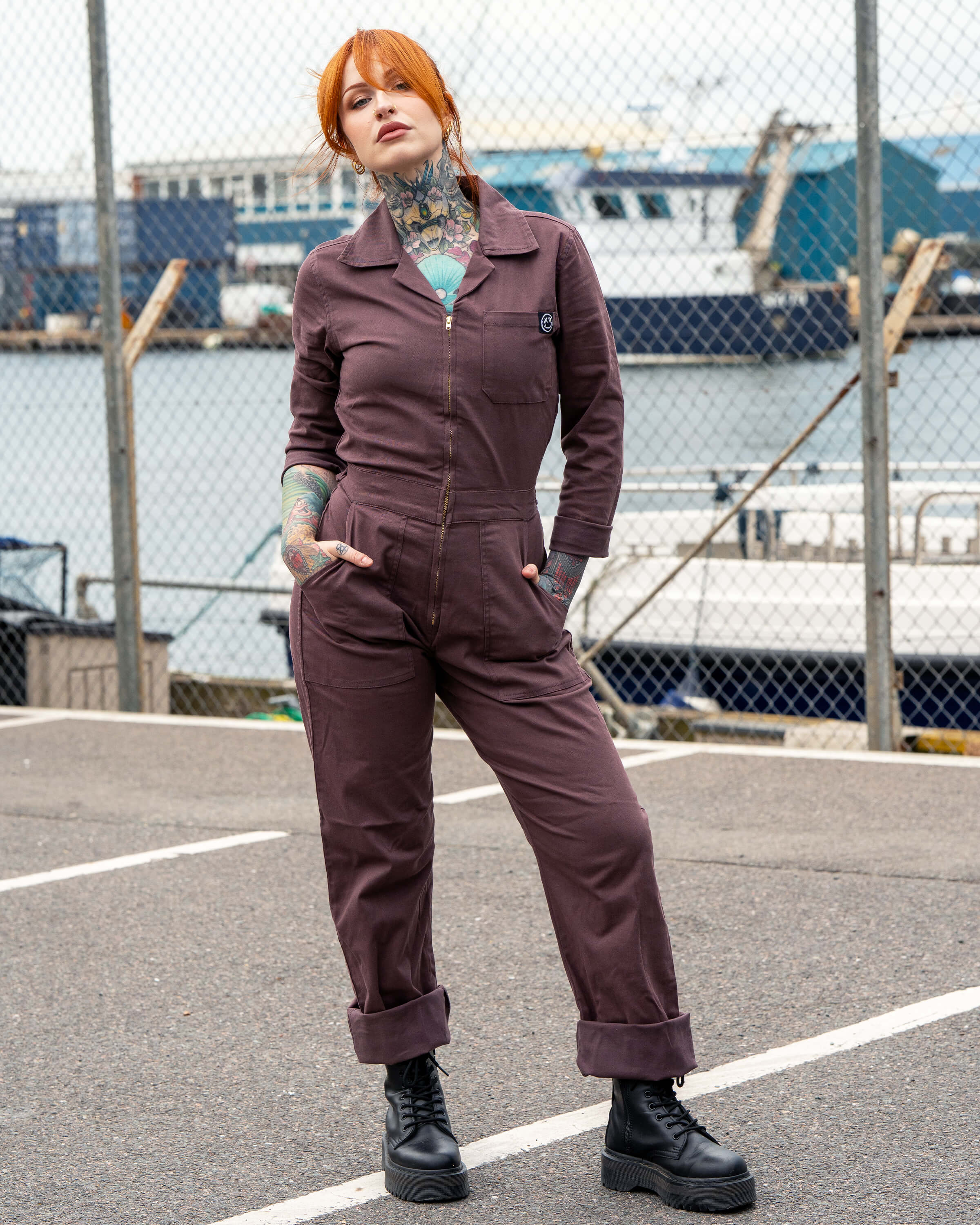 Rebel Romance Plum Mocha Boiler Suit modelled by Erin, styled with platform lace-up boots. The utility jumpsuit has a zip front, side pockets and turned-up hems, creating a bold workwear-inspired look perfect for alternative slow fashion.