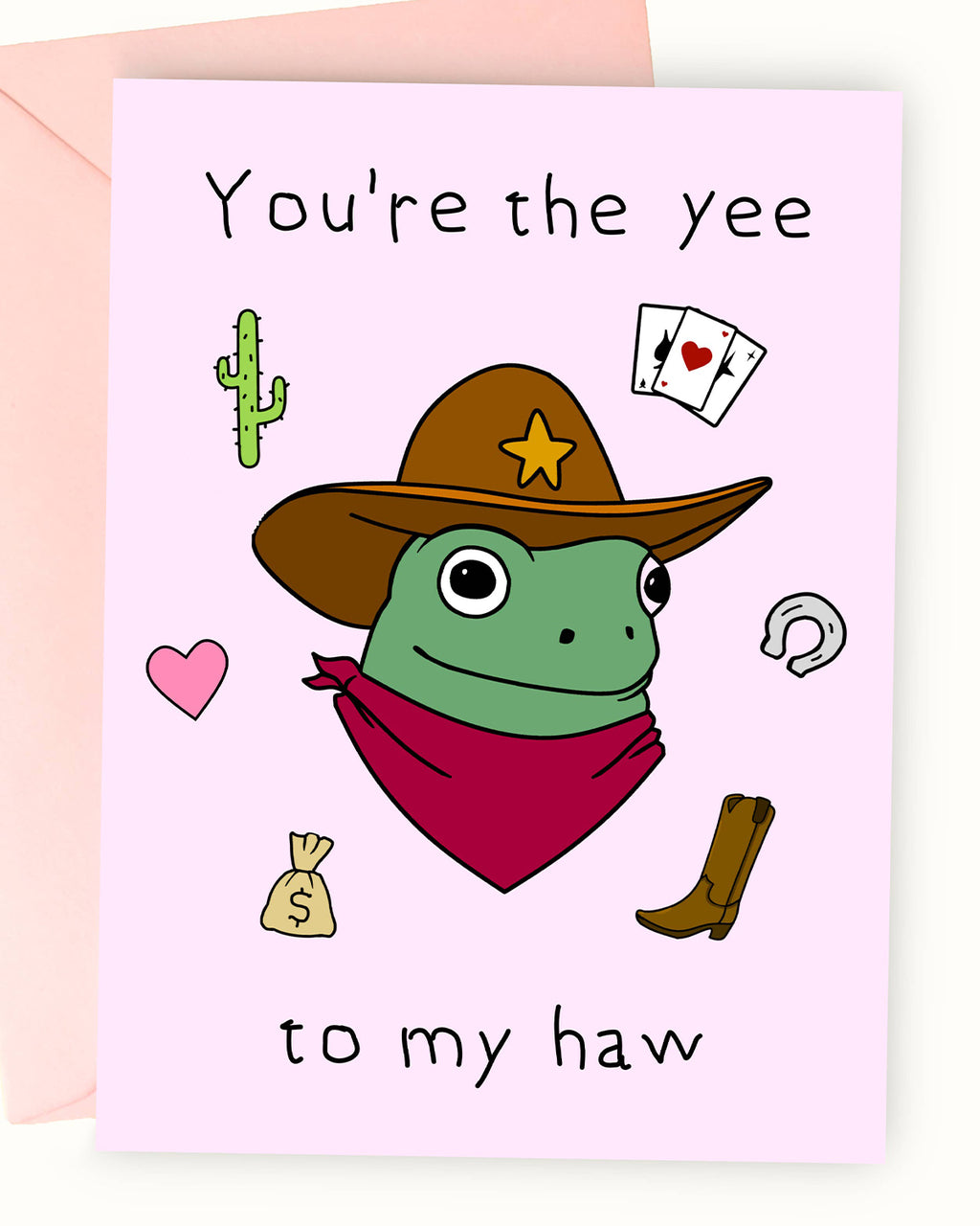pastel pink greeting card featuring an illustration by Nimbob of a cute green frog dressed as a cowboy. The frog wears a brown cowboy hat with a gold star, a red bandana, and has wide, friendly eyes. Surrounding the frog are whimsical doodles including a cactus, playing cards, a heart, a horseshoe, a cowboy boot, and a money bag. The text on the card reads: ‘You’re the yee to my haw’ in a playful, hand-drawn font. A perfect card for frog lovers, cowboys, and those who enjoy quirky and fun designs.