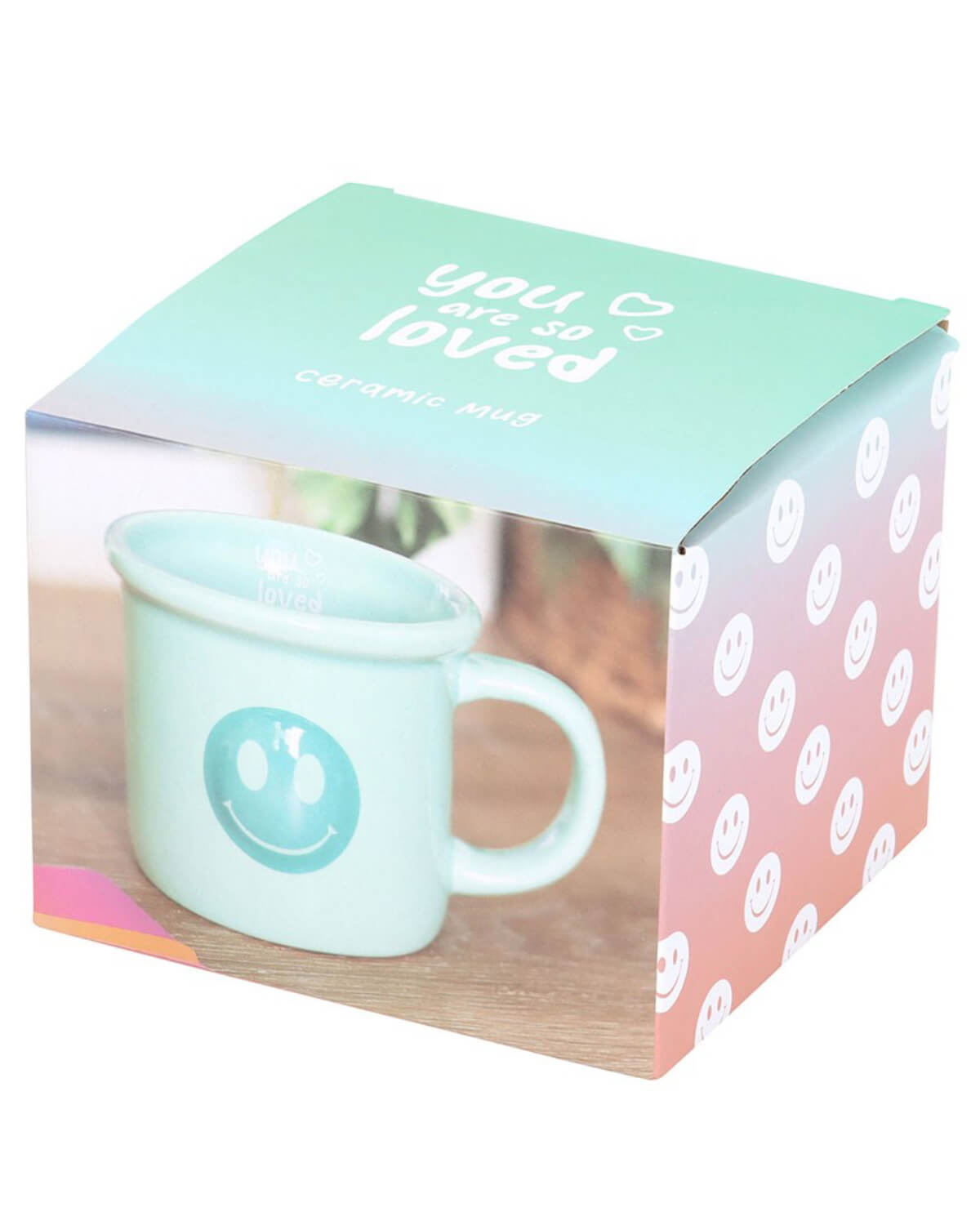 Mug packaged in a pastel gradient box with smiley face details and ‘You Are So Loved’ printed on the top.