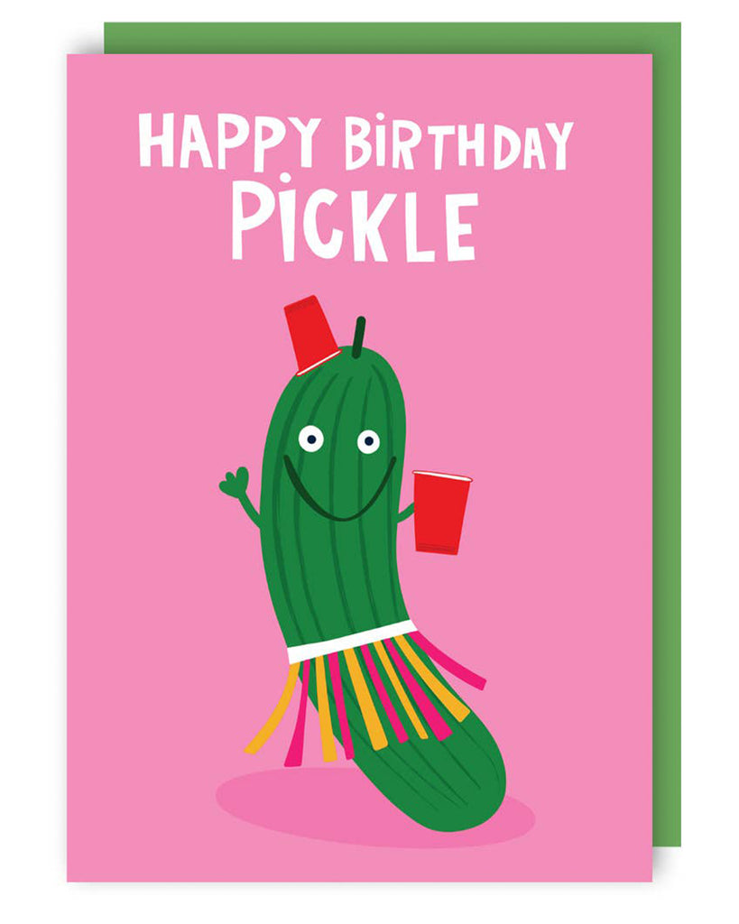 A birthday card featuring a cartoon illustration of a green pickle character wearing a colourful hula skirt, holding red party cups, and smiling. The text on the card reads 'HAPPY BIRTHDAY PICKLE'.