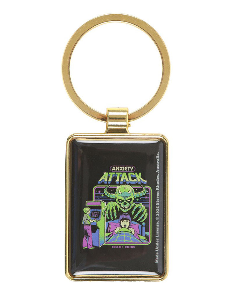 Front view of Anxiety Attack keyring by Steven Rhodes, with gold ring and retro enamel design of a child haunted by a green goblin monster. A fun, alternative keyring sold by Rebel Romance, a UK small business offering unique, retro and gothic gifts.