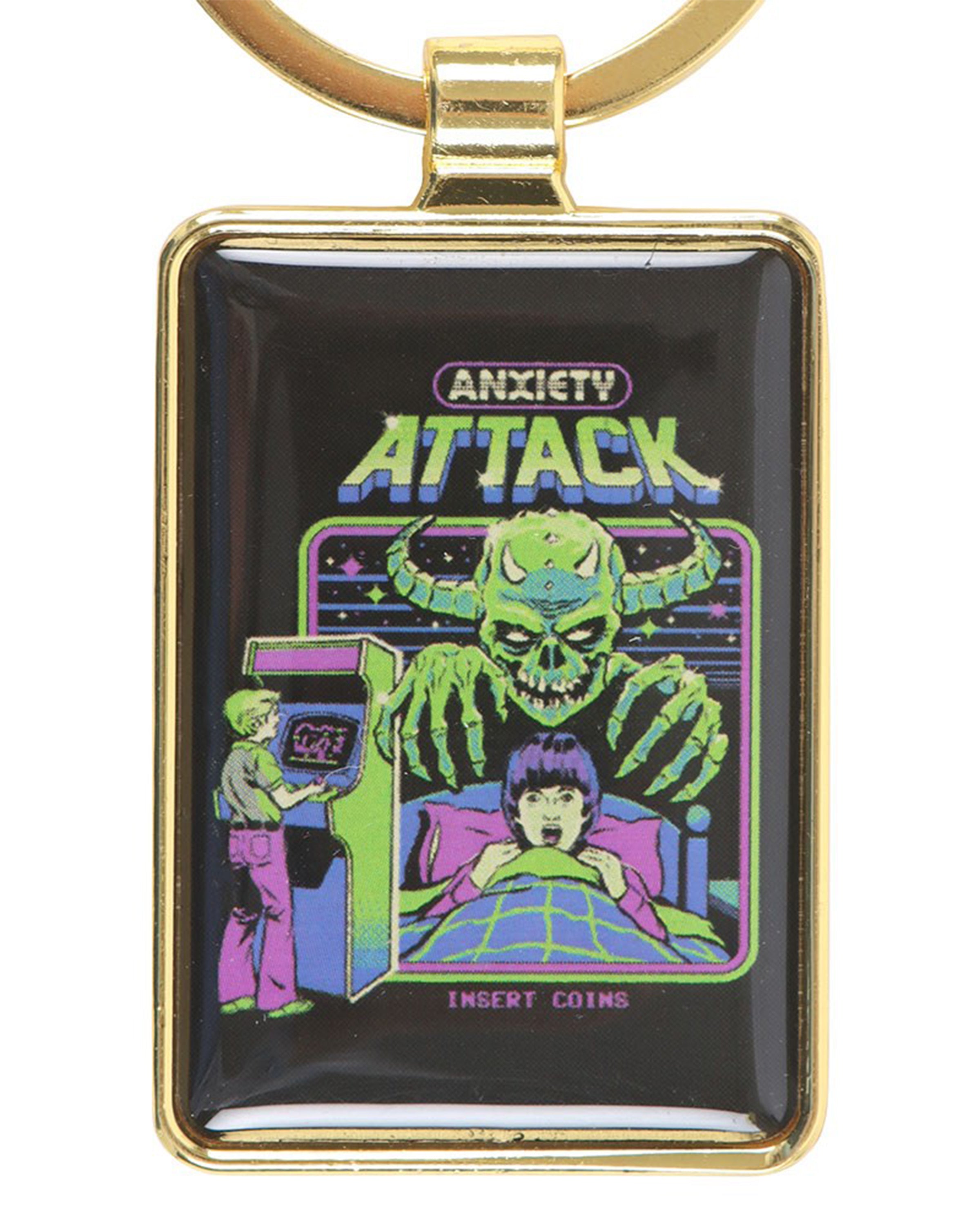 Rectangular Anxiety Attack keyring by Steven Rhodes, featuring retro arcade-inspired artwork of a green goblin-like monster looming over a terrified child in bed. A nostalgic alternative accessory sold by Rebel Romance, a UK small business celebrating quirky, gothic and retro gifts for millennials.