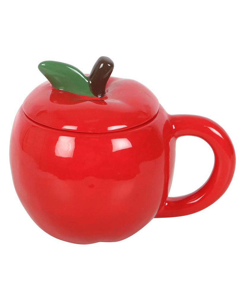 Side angle of the apple-shaped ceramic mug with green leaf and brown stem detail on the lid, photographed on white background.