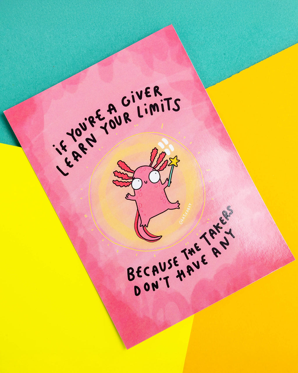 A postcard of a pink axolotl in a bubble holding a wand. With text saying if you're a giver learn your limits because the takers don't have any on a pink background. Illustrated by Katie Abey.