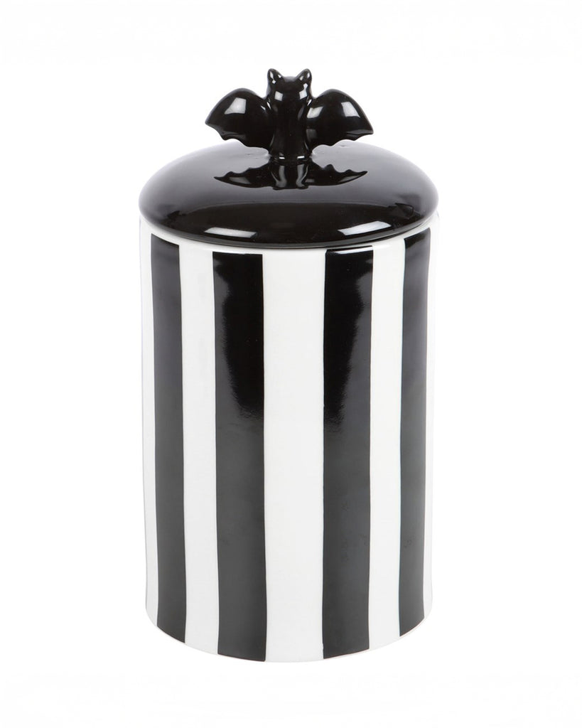A black and white striped ceramic storage jar with a glossy bat-shaped lid handle. The bold design gives off a gothic and alternative aesthetic, making it perfect for quirky home décor.