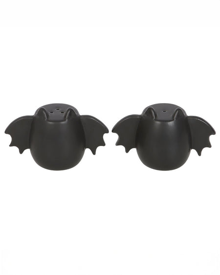 Two black ceramic bat-shaped salt and pepper shakers, side by side, with small holes for seasoning. A must-have for Halloween lovers and alternative homeware collectors.