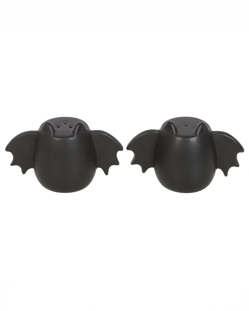 Two black ceramic bat-shaped salt and pepper shakers, side by side, with small holes for seasoning. A must-have for Halloween lovers and alternative homeware collectors.