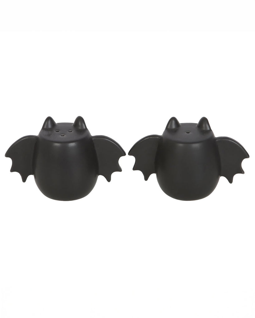 A close-up of the bat wing salt and pepper shakers, showcasing their matte black ceramic finish and unique winged design. A stylish and spooky addition to any kitchen.